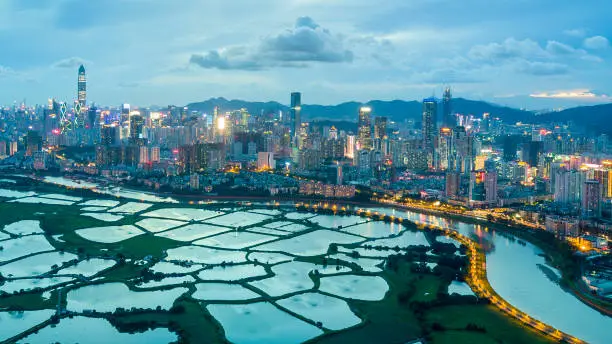 Dusk aerial shot of fish farms next to a metropolis - Hongkong Shenzhen Border