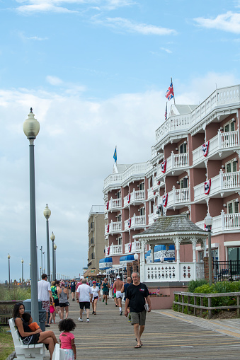 Rehoboth Beach, USA - July 3, 2022. People walking on boardwalk by Boardwalk Plaza Hotel at Rehoboth Beach, Delaware, USA
