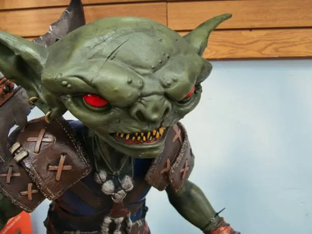 Fantasy Green Goblin Character with Huge Ears and Red Eyes