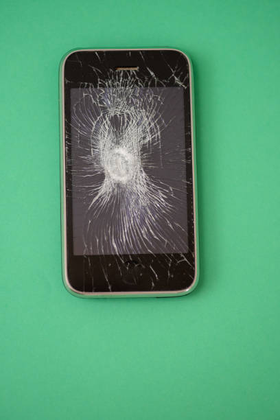 High angle view of cellphone with cracked screen