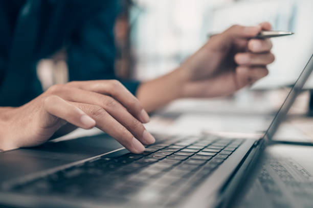 istock Investors working on desk office and use computer keyboard and laptop  to check data cost, balance, profit and  currency. Accounting and  Financial concept. 1408150378