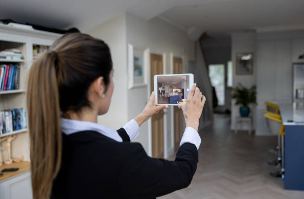 Real estate agent making a virtual tour of a house using a tablet Real estate agent making a virtual tour of a house using a tablet - real estate showing concepts how to sell my photography online stock pictures, royalty-free photos & images