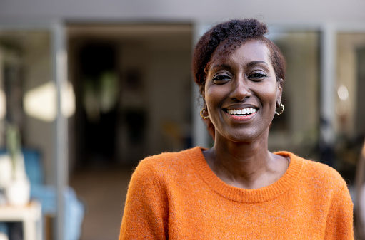 Portrait of a happy African American woman smiling at home and looking at the camera