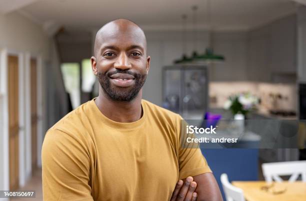 Portrait Of A Happy Man Smiling At Home Stock Photo - Download Image Now - Men, Portrait, Black People