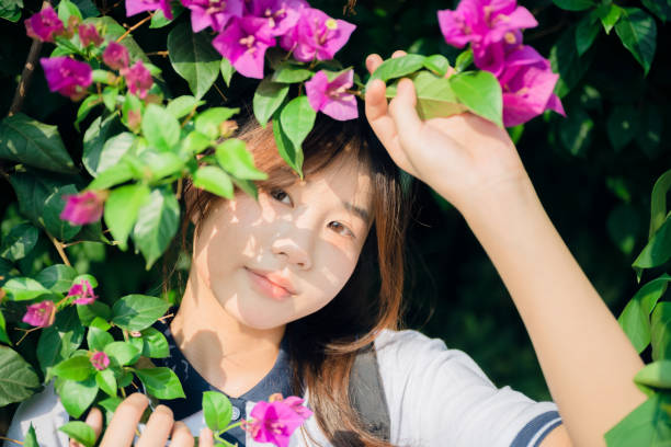 istock Asian girls under flowers 1408150707