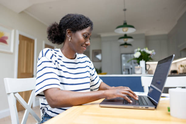 istock Happy black woman working at home on her laptop 1408150738