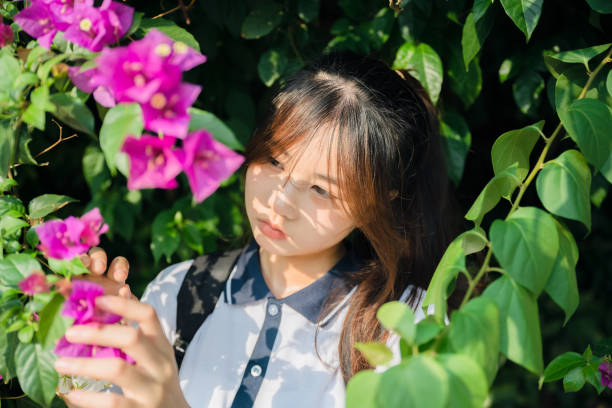 istock Asian girls under flowers 1408150742