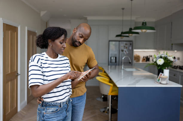 istock Couple controlling their smart home using a mobile app on a tablet 1408150766