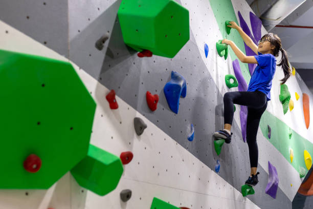 Girl climbing on indoor bouldering wall