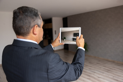 Real Estate Agent making a virtual tour of a house using a tablet computer - real estate concepts