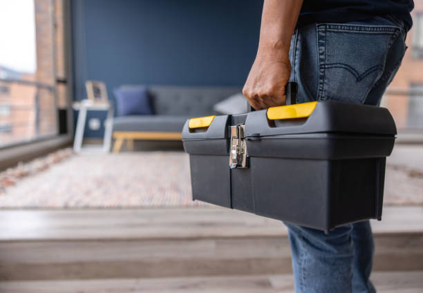 Close-up on an electrician carrying a toolbox while working at a house Close-up on an electrician carrying a toolbox while working at a house - domestic life concepts toolbox stock pictures, royalty-free photos & images