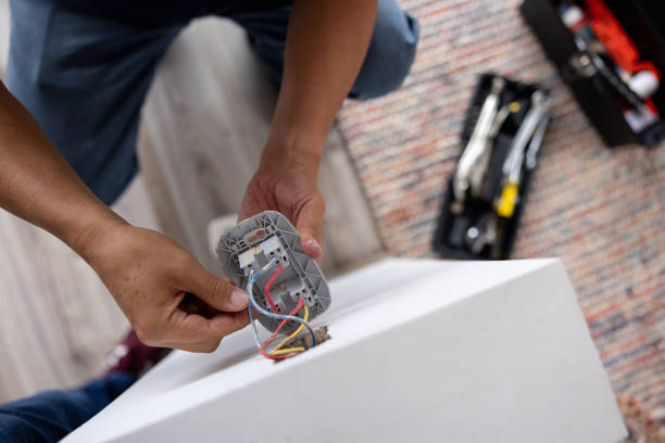Close-up on a repairman fixing an electrical outlet stock photo