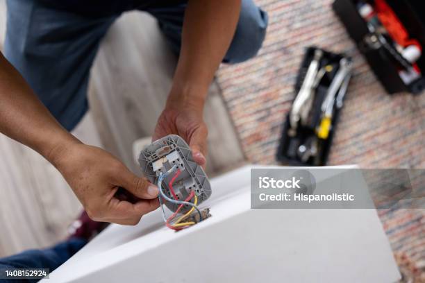 Closeup On A Repairman Fixing An Electrical Outlet Stock Photo - Download Image Now