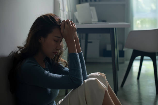 istock Woman sitting on floor at home feeling sad, life difficulties. 1408153689
