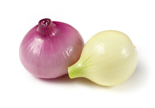 Two young peeled bulbs on a white background. Fresh vegetables close-up.