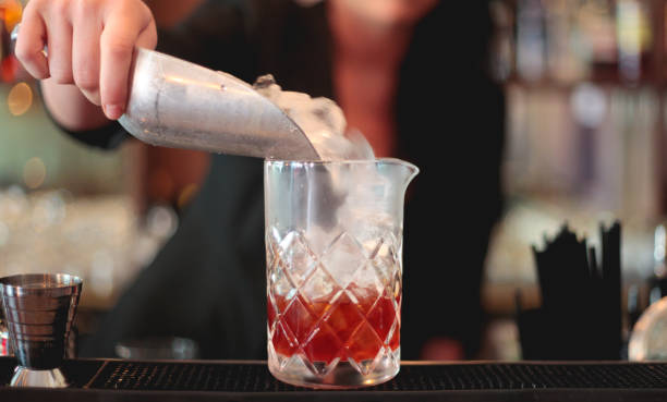 istock Ice Being Tipped into a Cocktail Glass 1408155691