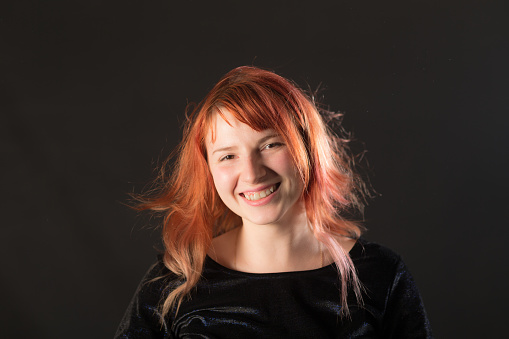 studio portrait of a girl with red hair