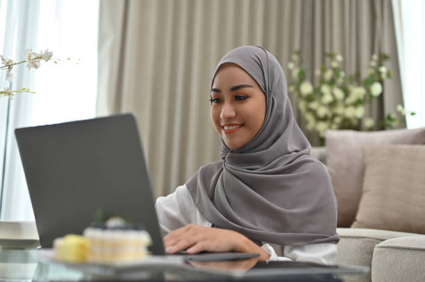 istock Beautiful Asian Muslim woman using laptop computer 1408156035