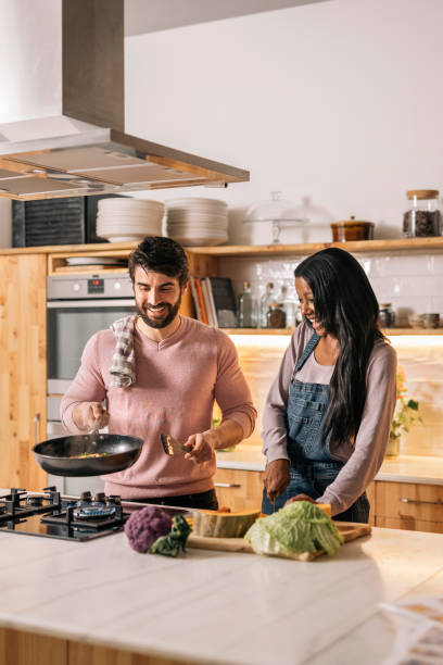 istock Happy Couple Cooking at Home 1408158174