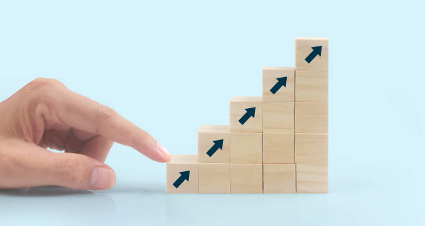 Business connecting piece of multi wood chart blocks steps in hand stock photo