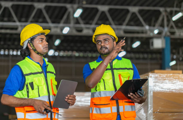 istock Workers team taking inventory in factory warehouse, Manual workers working in warehouse talking about job 1408161070