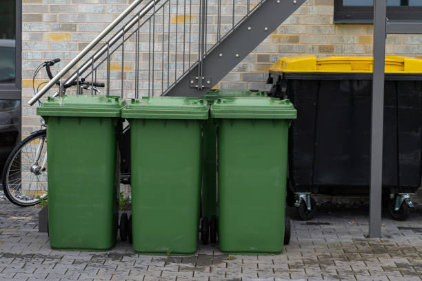 istock Three green trash cans in front of a residential building. 1408161453