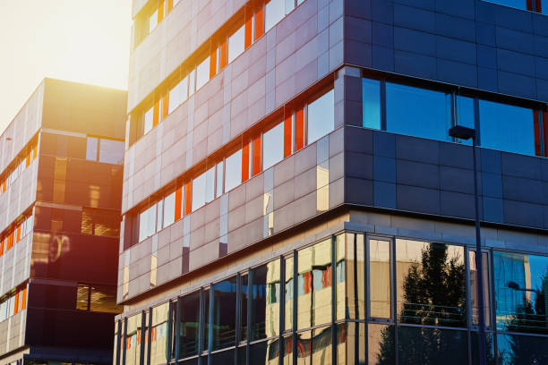 Modern office building with green trees Facade of buiding at sunset, Modern office building in city for business corporation, Residential contemporary business architecture blue people stock pictures, royalty-free photos & images