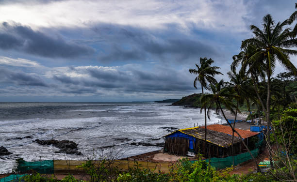 Vagator beach in north Goa on a windy and cloudy day during monsoon season Shot at Vagator beach in north Goa, India on a day during the monsoon or rainy season monsoon stock pictures, royalty-free photos & images