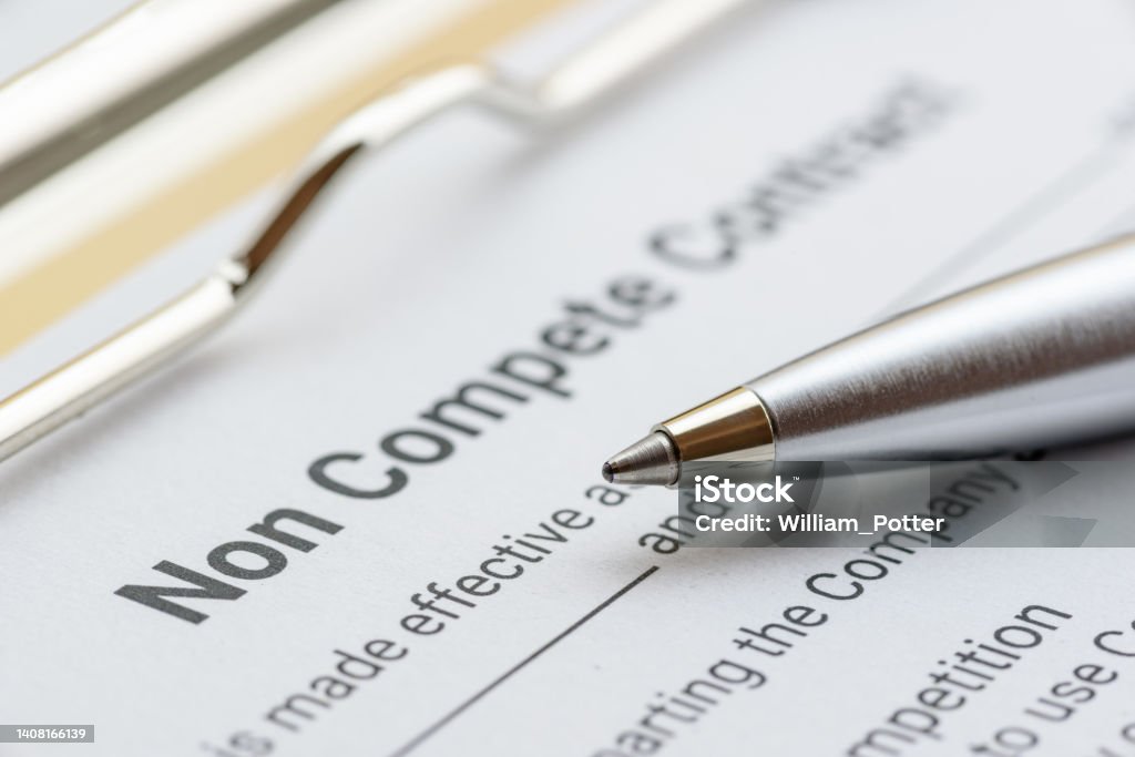Blue ballpoint pen on a non compete contract. Noncompete contract is an agreement between employee and employer, not to enter into competition in subsequence business effort. Legal concept. Legal concept : Blue ballpoint pen on a non compete contract. Noncompete contract is an agreement between employee and employer, not to enter into competition in subsequence business effort. Contract Stock Photo