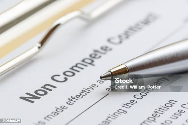 Blue Ballpoint Pen On A Non Compete Contract Noncompete Contract Is An Agreement Between Employee And Employer Not To Enter Into Competition In Subsequence Business Effort Legal Concept Stock Photo - Download Image Now
