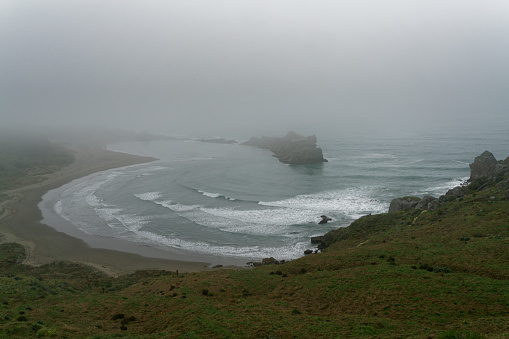 The Gap on a misty morning at Castle Point, near the lighthouse, Wairarapa, north island, Aotearoa /New Zealand.