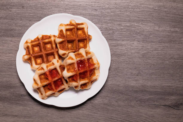 istock Four waffles in a white plate.and gray background. 1408166359