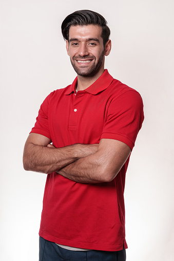 Studio portrait photo of young handsome Middle East man in red shirt on white background making various pose and emotion.