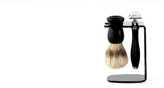 old style Razor, brush, on a stand  against a white background