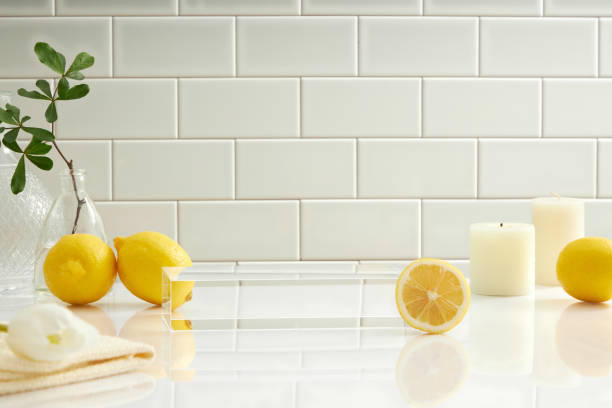 istock Front view lemon decorated with cosmetic jar towel sink in ceramic tile background 1408173713