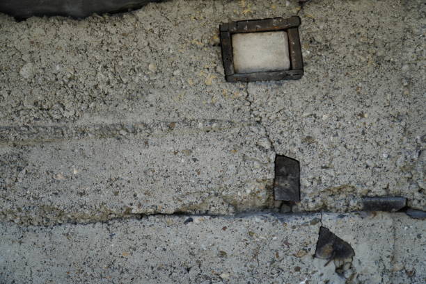 istock Fragment of an old concrete wall with wood inserts, close-up 1408173908