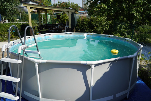 Round pool with water in the garden.