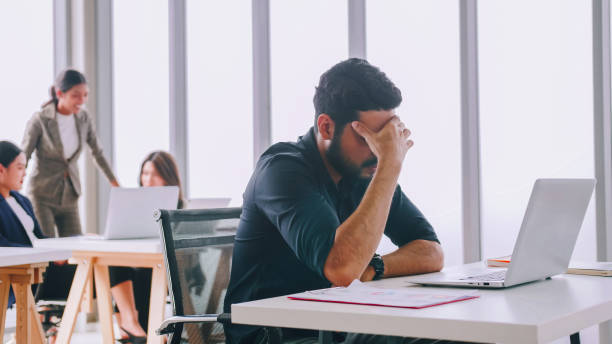 istock A young company employee is feeling tired while sitting at work for a long time. 1408173999
