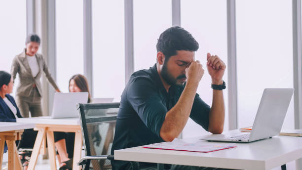 istock A young company employee is feeling tired while sitting at work for a long time. 1408174003