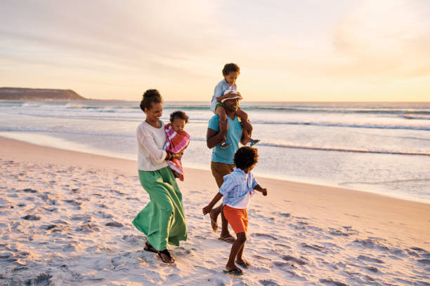 istock Copyspace with a family walking on the beach while relaxing at sunset during a fun summer vacation and getaway together. Loving parents bonding with their little kids and enjoying a break to travel 1408176390
