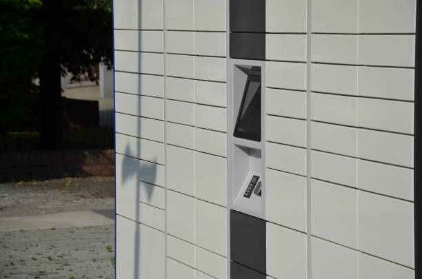 istock Male client using an automated self-service terminal or locker to place a package to store goods from an online store. after paying by card or mobile phone, the box opens and the goods are issued 1408178707