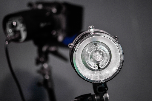 Studio lamp. Lighting equipment for photo and video shooting. Spotlight on a tripod