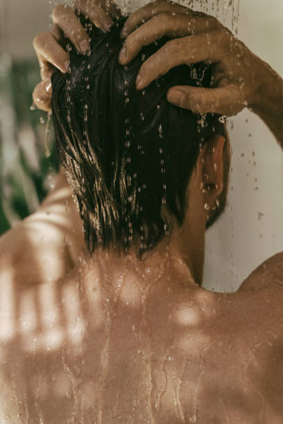 istock Young man having a shower outdoors. 1408178940