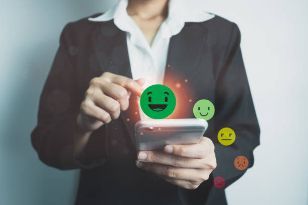 istock Customer satisfaction concept, client is satisfied with pressing smile face icon by smart phone, excellent service, impressed with care, highest rating and score, good feedback from users. 1408178992