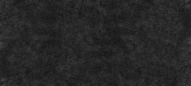 istock Fine textured shabby black surface wide abstract background. Dark gray spotty grainy texture. Gloomy grunge widescreen wallpaper 1408181958