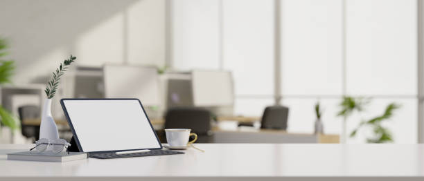 istock Modern workspace tabletop with tablet mockup and copy space over blurred office background 1408182875