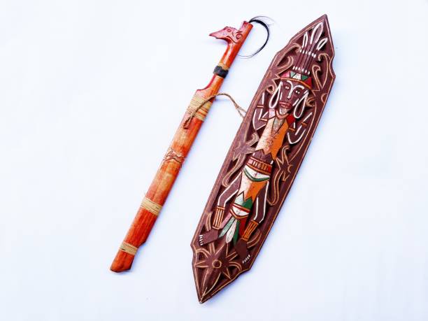 Mandau and Tameng. Mandau is Indonesian traditional sword from Dayak tribe and Tameng is Indonesian traditional shield Dayak tribe made from wood or iron with traditional carving. Isolated on white