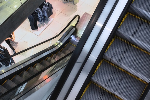 Escalators in a clothes shop in a department store or shopping mall