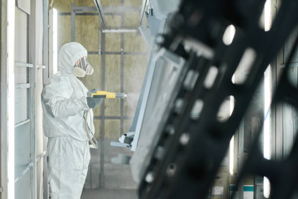 istock Worker in protective wear painting details 1408191222