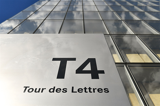 Paris, France-07 05 2022: Detail of the name ( The tower of  letters) of one of the four towers of the the Bibliothèque nationale de France, François-Mitterrand site, located in Paris.The National Library of France, designed by architect Dominique Perrault is a public establishment under the supervision of the Ministry of Culture. Its mission is to constitute collections, especially the copies of works published in France that must, by law, be deposited there, conserve them, and make them available to the public.